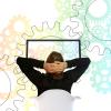 Photo of a person with their hands on the back of their head, looking at a screen with drawings of gears in the background